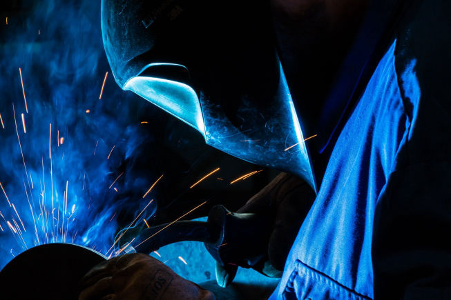 Image of Man Welding with sparks flying